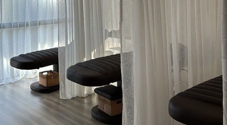 Relaxing massage beds with soft curtains at Beaute Society in Rosebery, New South Wales, AU.