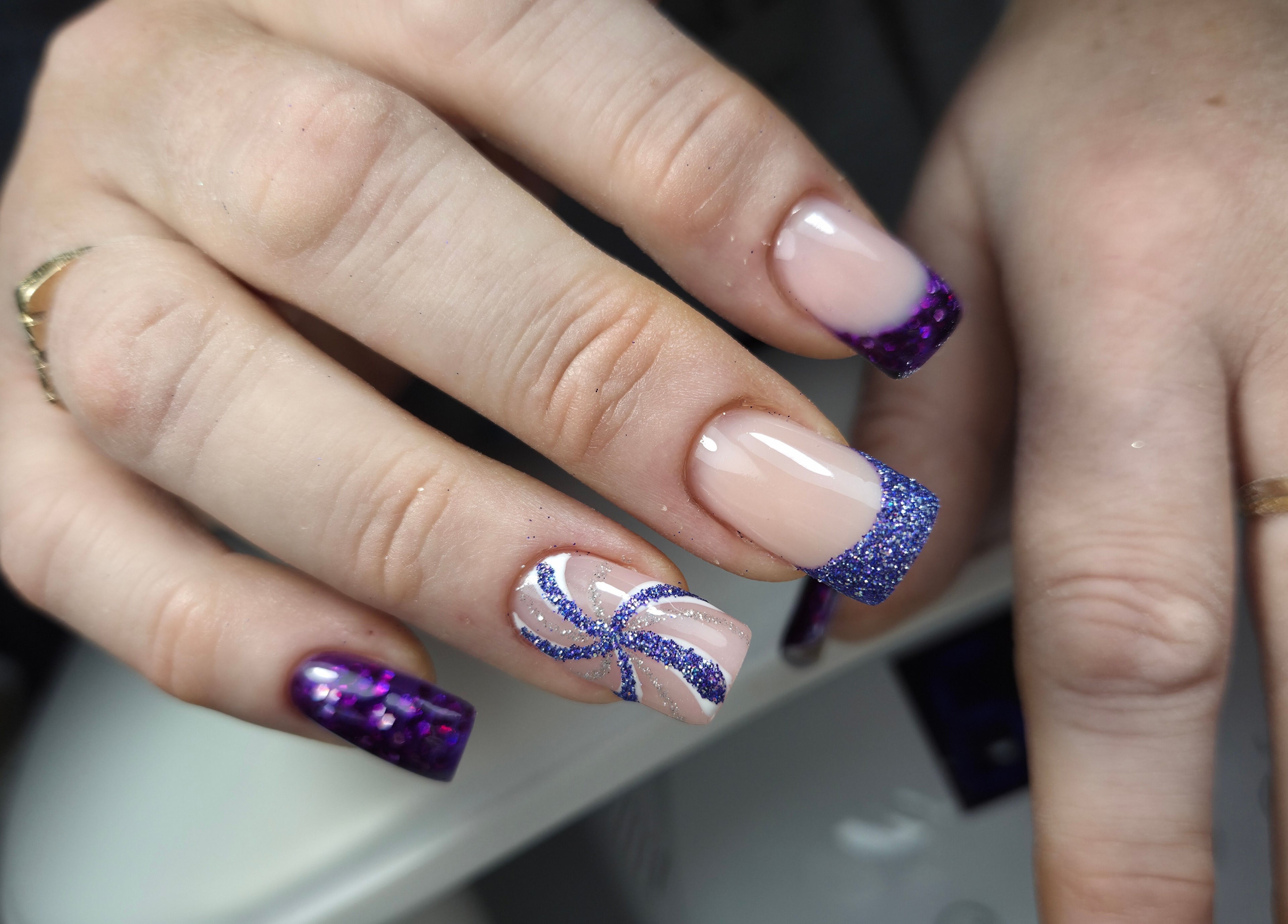 Purple glitter manicure at Gloss & Glitter, Petworth, England, GB. Perfect for stylish nail art lovers.