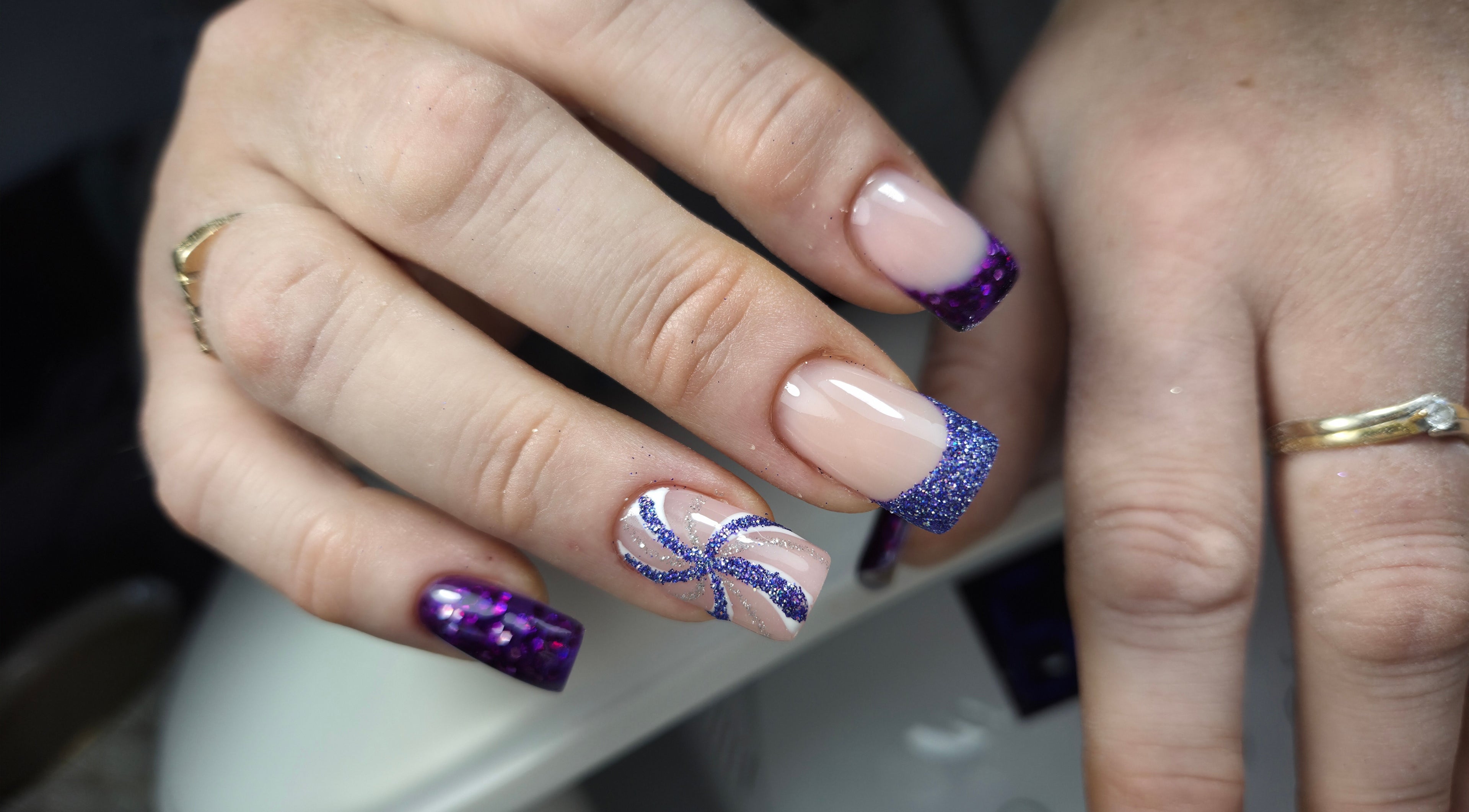 Purple glitter manicure at Gloss & Glitter, Petworth, England, GB. Perfect for stylish nail art lovers.