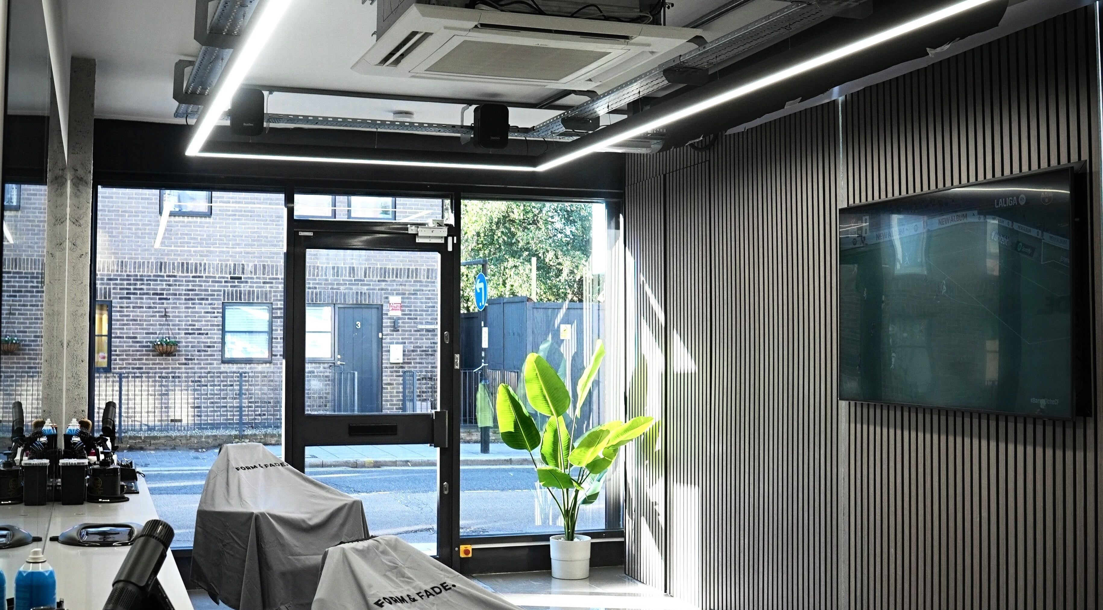 Sleek interior of Form & Fade, South Croydon, England, GB with natural light and stylish decor.