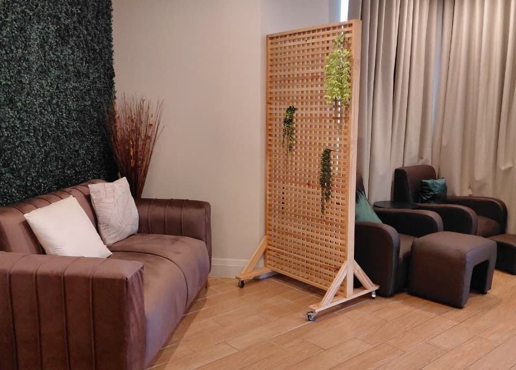 Relaxing lounge area at Orchard Day Spa at Apart Hotel, Umhlanga, Kwazulu-natal, ZA with plush seating and greenery.