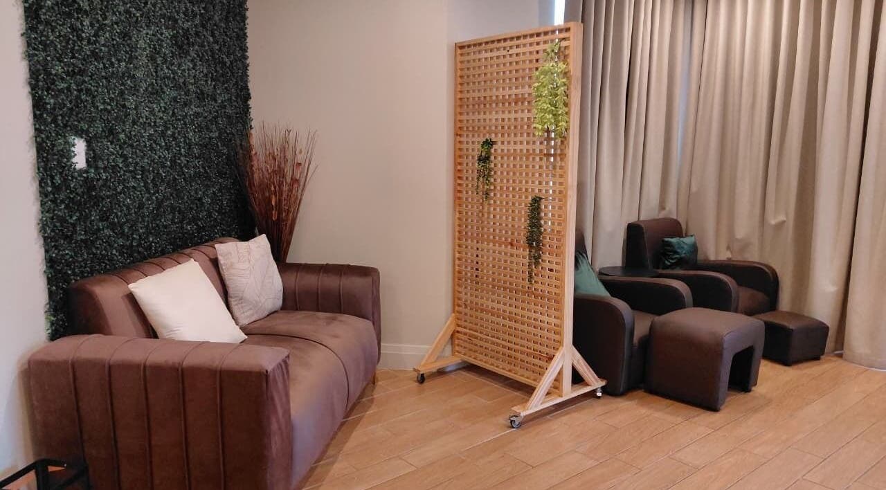 Relaxing lounge area at Orchard Day Spa at Apart Hotel, Umhlanga, Kwazulu-natal, ZA with plush seating and greenery.