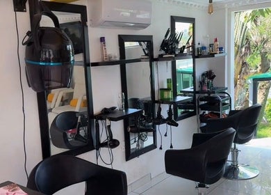 Modern salon interior at Mellyz Beauty Studio, Randburg, Gauteng, ZA with contemporary decor and styling chairs.