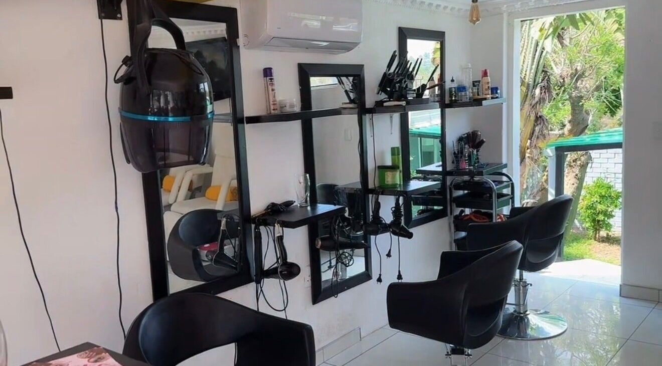Modern styling area at Mellyz Beauty Studio, Randburg, Gauteng, ZA with sleek chairs and large mirrors.