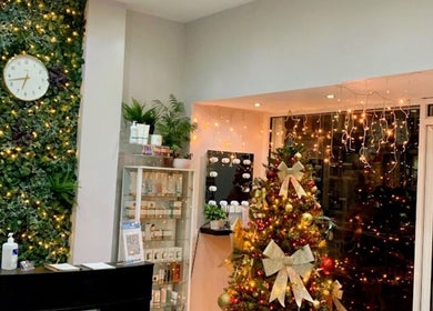 BeautybyLgs in Gateshead, England, adorned with Christmas decor, green wall, and beauty products display.