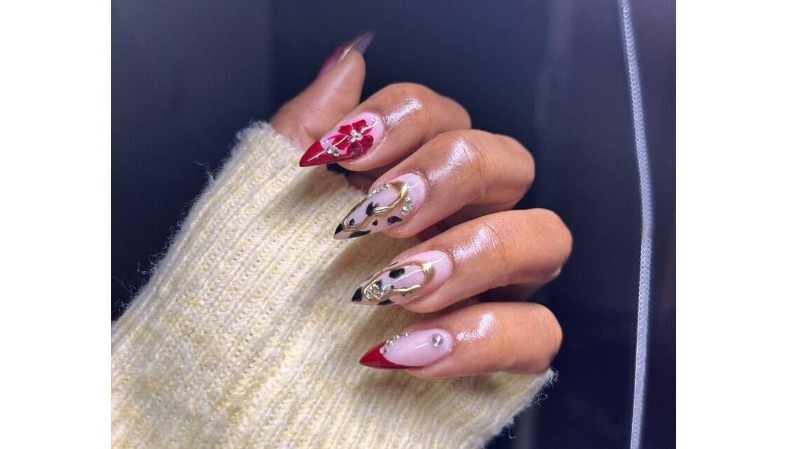 Artistic nail design at Pink_Aura_Nails, Cape Town, Western Cape, ZA, showcasing intricate red and gold nail art.