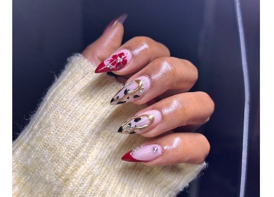 Artistic nail design at Pink_Aura_Nails, Cape Town, Western Cape, ZA, showcasing intricate red and gold nail art.