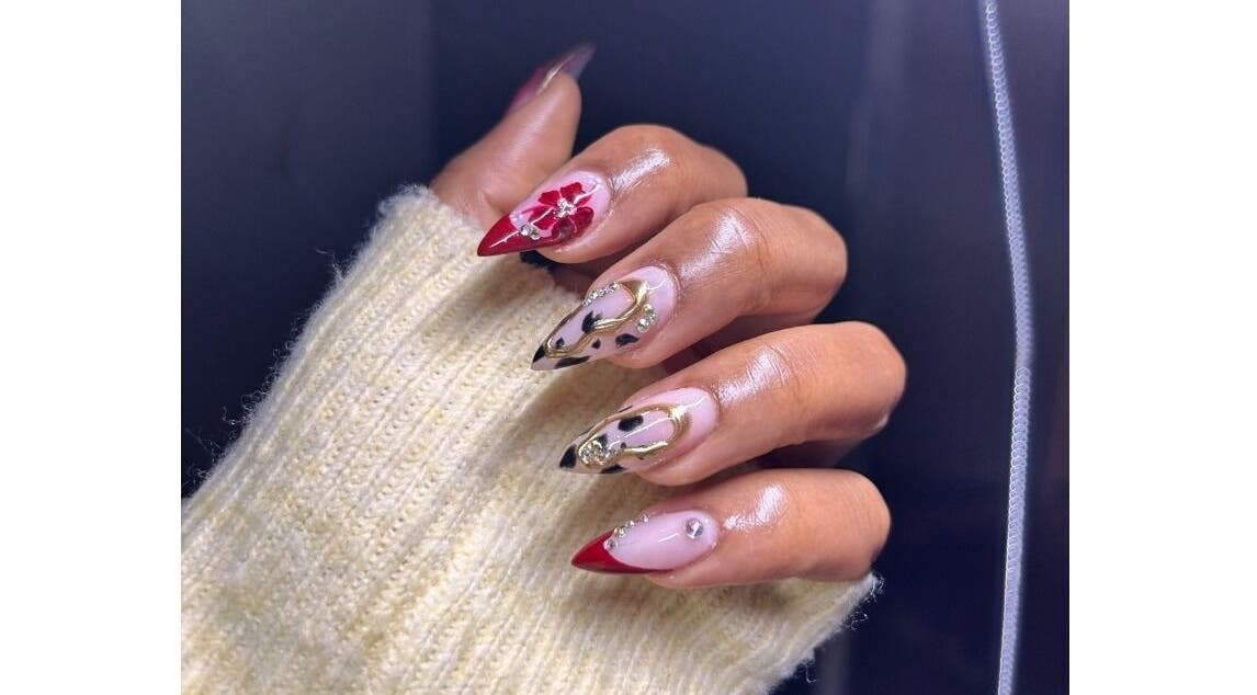 Artistic nail design at Pink_Aura_Nails, Cape Town, Western Cape, ZA, showcasing intricate red and gold nail art.