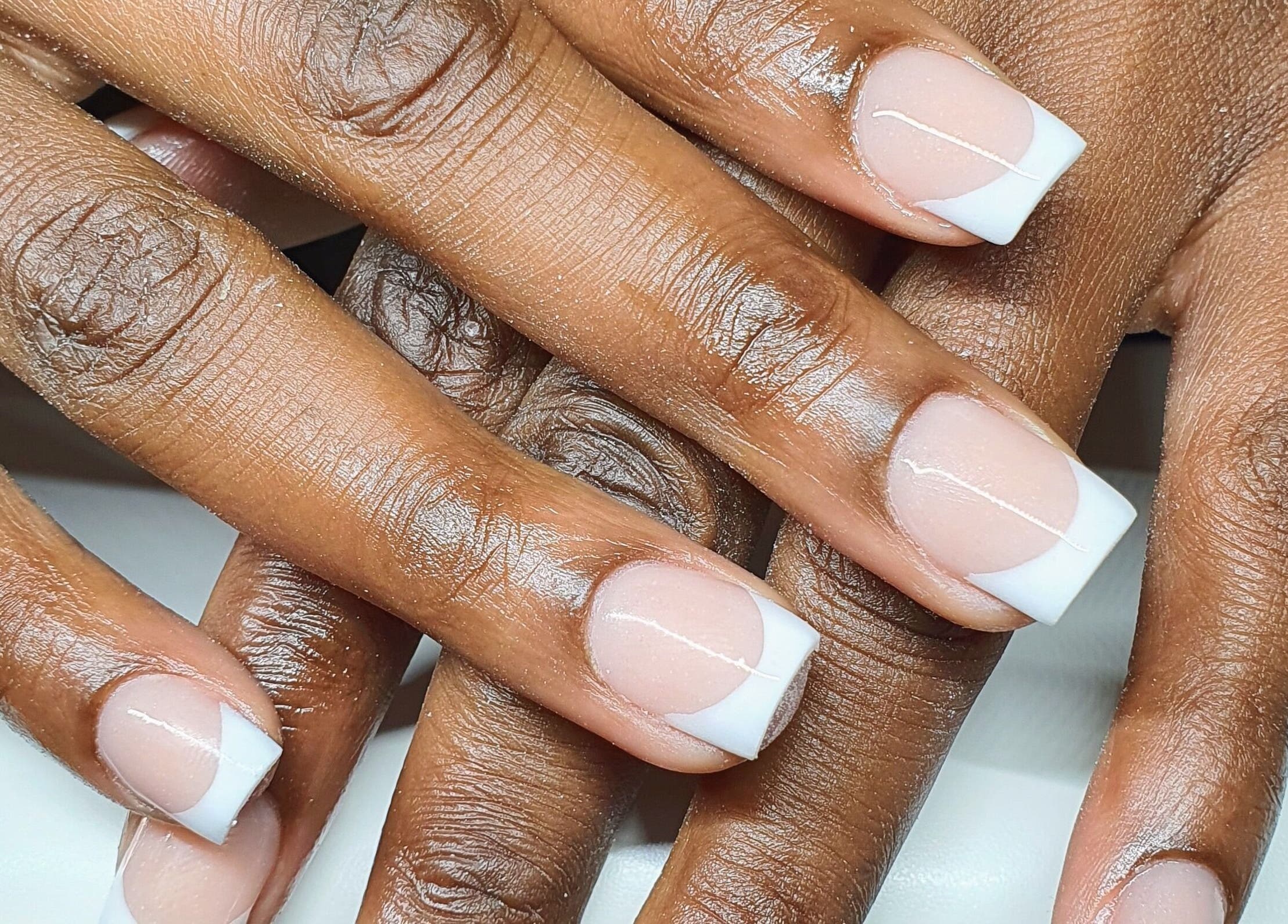 Elegant French manicure at Pink_Aura_Nails, Cape Town, Western Cape, ZA showcasing neat white tips on nails.