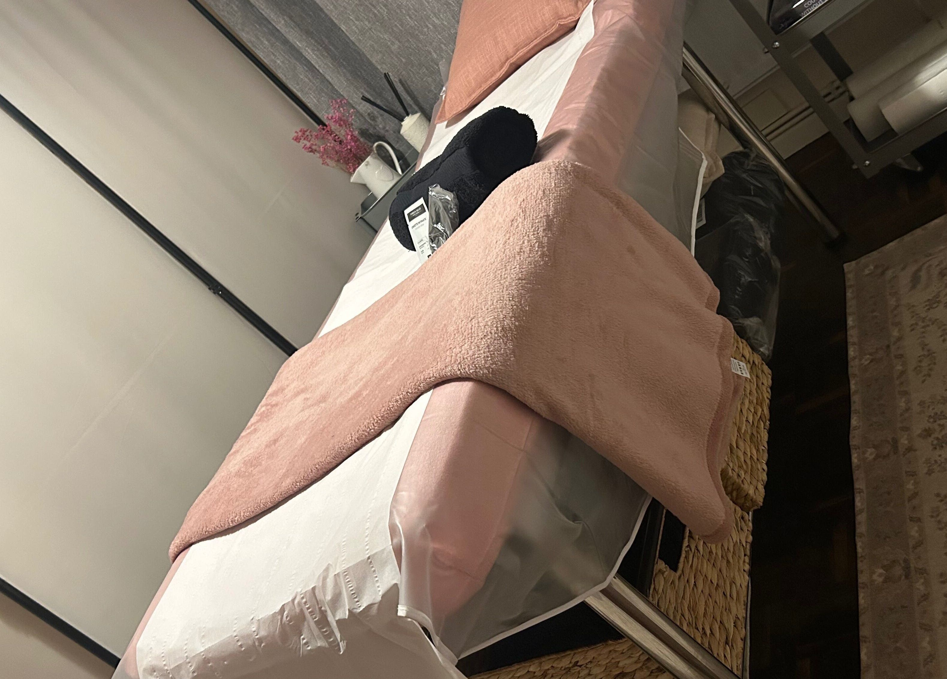 Cozy waxing room at Bare & Bonnie Waxing, Banbury, England, GB, featuring a plush bed with soft pink accents.