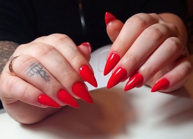 Яскраві червоні манікюрні нігті у салоні Manicure Pedicure в Pruszków, Województwo Mazowieckie, PL.