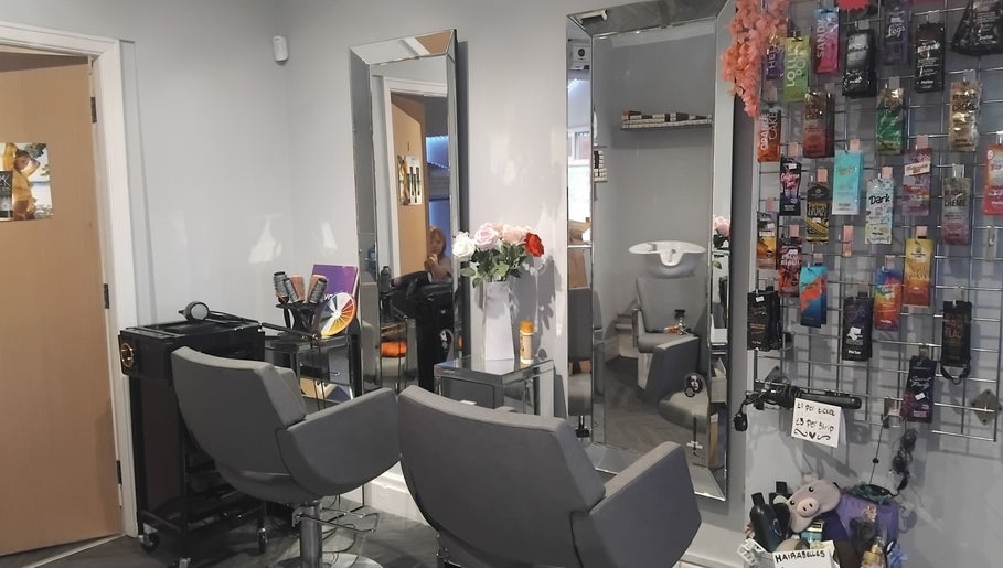 Interior of Hairabelles salon in Bolton, England, GB with mirrors, chairs, and hair products displayed.