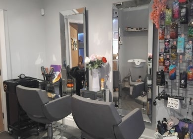 Interior of Hairabelles salon in Bolton, England, GB with mirrors, chairs, and hair products displayed.