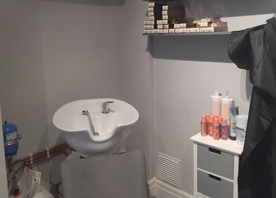 Hairabelles salon wash station in Bolton, England, GB with modern sink and haircare products.