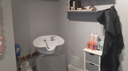 Hairabelles salon wash station in Bolton, England, GB with modern sink and haircare products.