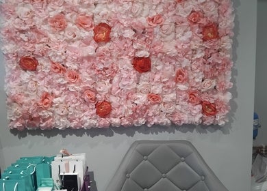 Vibrant floral wall decor at Hairabelles, Bolton, England, GB enhancing the welcoming salon ambiance.