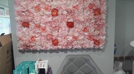 Vibrant floral wall decor at Hairabelles, Bolton, England, GB enhancing the welcoming salon ambiance.