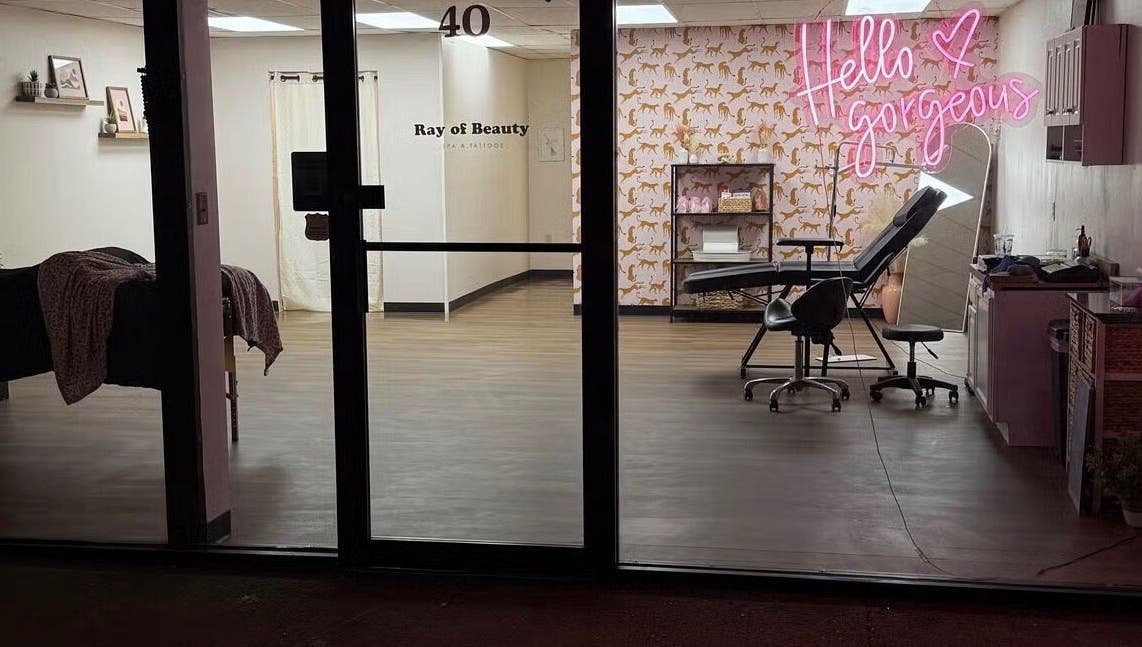 View of Esthetics by Abbi in Chillicothe, Ohio with 'Hello Gorgeous' neon sign and beauty station.