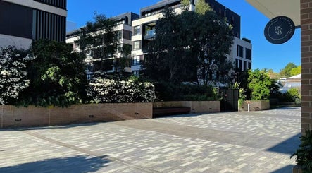 Entrance of Hydra Skin Spa Beauty in Leichhardt, New South Wales, AU, surrounded by lush greenery.