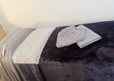 Cozy massage bed at Hydra Skin Spa Beauty, Leichhardt, New South Wales, AU, ready for a relaxing session.