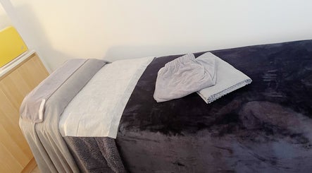 Cozy massage bed at Hydra Skin Spa Beauty, Leichhardt, New South Wales, AU, ready for a relaxing session.