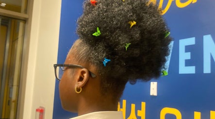 Woman with colorful hair clips at Slaynama, New York, New York, US. A stylish representation of natural hair beauty.