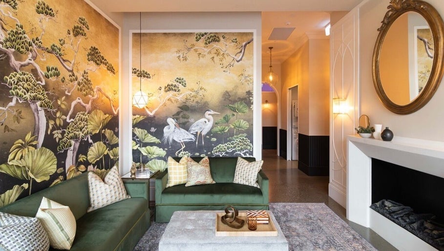 Elegant lounge at Bonded- hair by Tess in Melbourne, Victoria, AU with scenic wallpaper and cozy seating.