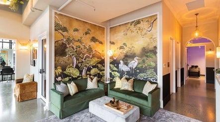 Elegant lounge in Bonded- Hair by Tess, Melbourne, Victoria, AU featuring artistic decor and plush seating.