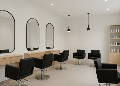 Sleek salon interior at RawLockerz in Fort Lauderdale, Florida, US with modern styling chairs and mirrors.