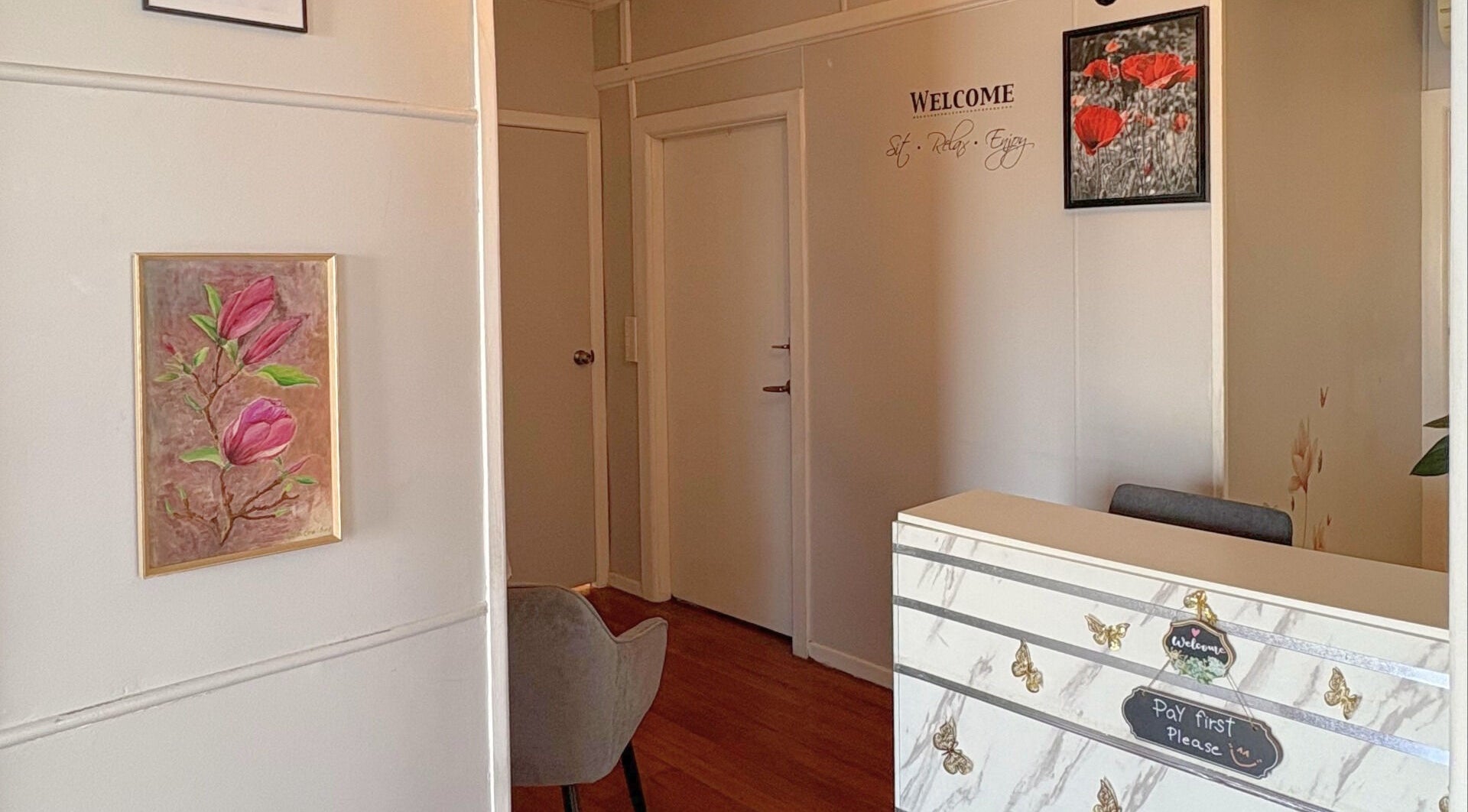 Reception area at Let’s Relax Thai Massage By Alice in Gisborne, Gisborne Region, NZ with floral art.