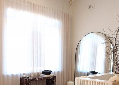 Elegant interior of The Lune Nails in Perth, Western Australia, AU featuring a round mirror and minimalist decor.