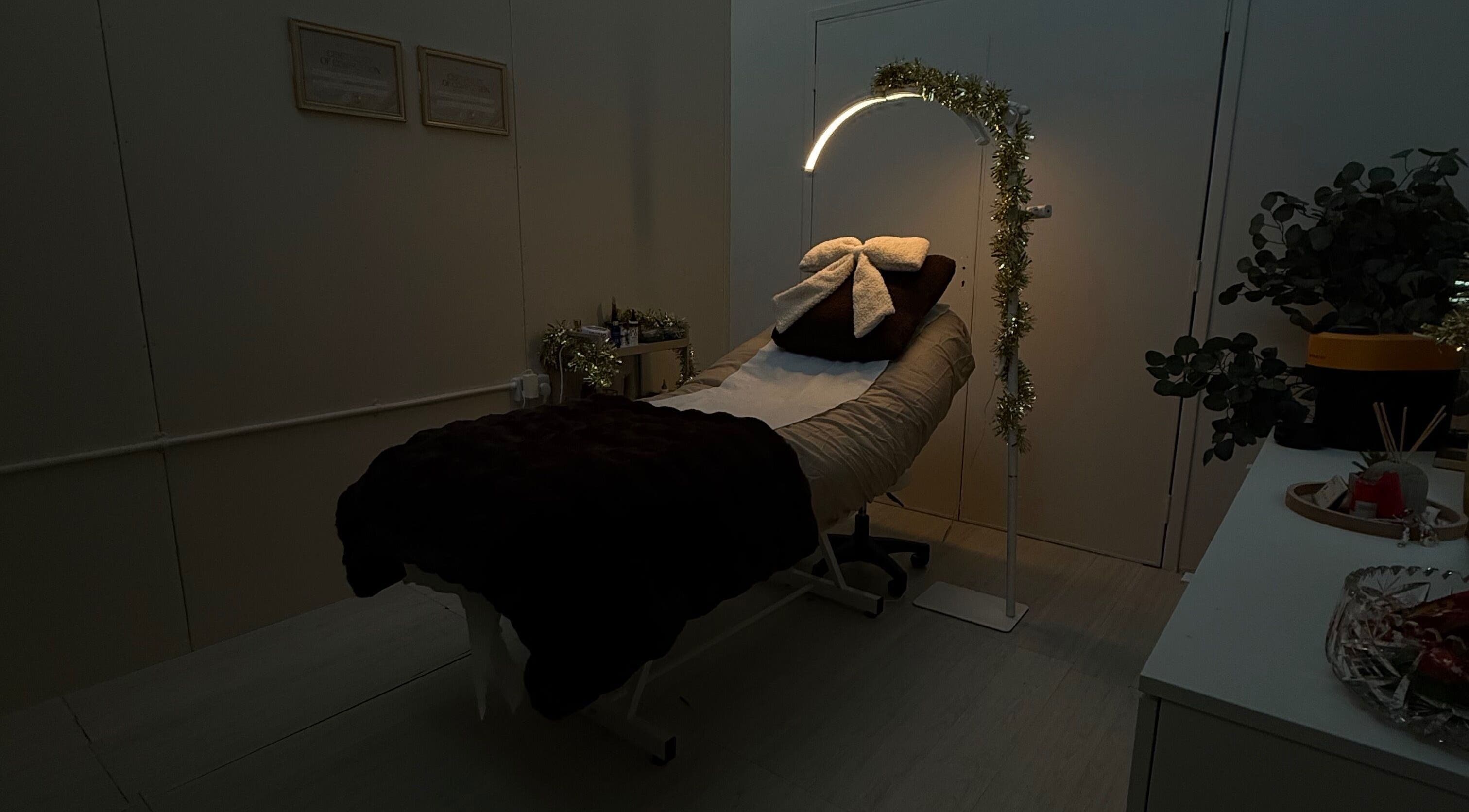 Cozy treatment room at The Brow Department in Wembley, England, GB, featuring a stylishly decorated therapy bed.