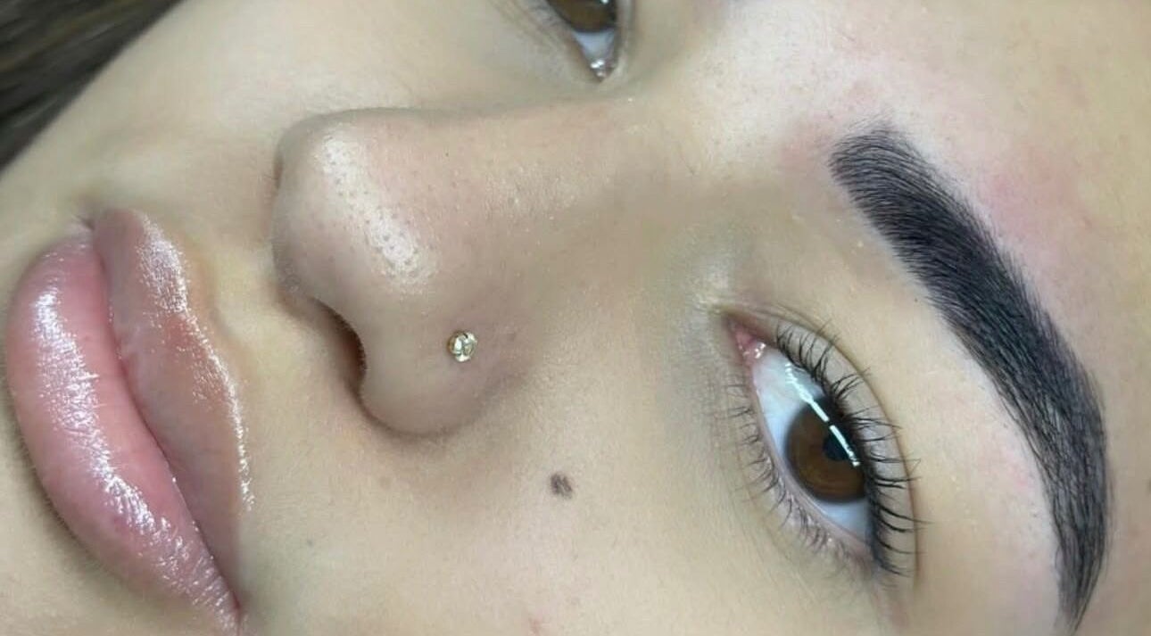 Close-up of flawless skin, full lips, and well-groomed eyebrows at Kae & Co Beauty Bar, Lakelands, Western Australia, AU.