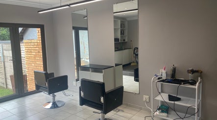 Modern salon interior at Faded by Avril, located in Centurion, Gauteng, ZA, showcasing sleek chairs and mirrors.