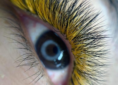 Close-up of eye with vibrant golden lashes at Blooming Brows Beauty, Ocean Reef, Western Australia, AU.