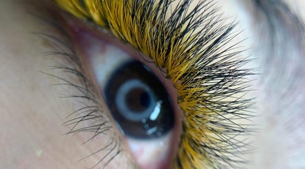 Close-up of eye with vibrant golden lashes at Blooming Brows Beauty, Ocean Reef, Western Australia, AU.