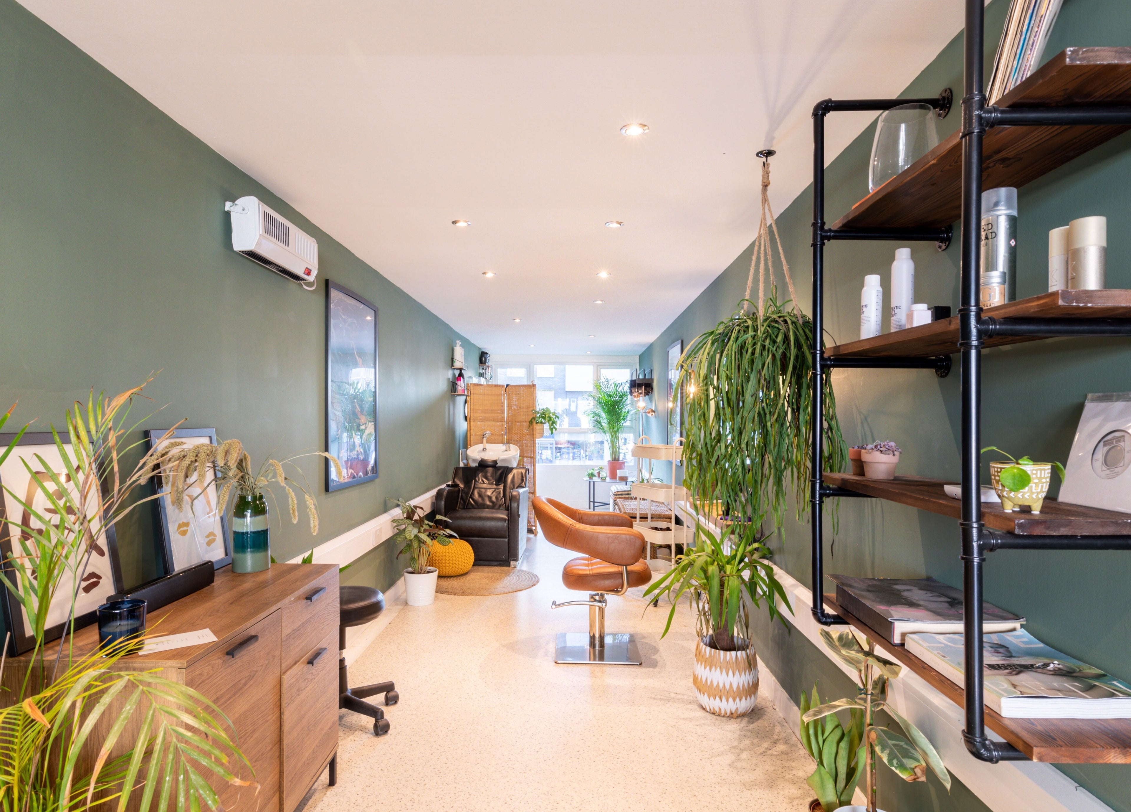 Sophisticated interior of Re:Create Hair Studio in London, England, GB with modern decor and styling chairs.