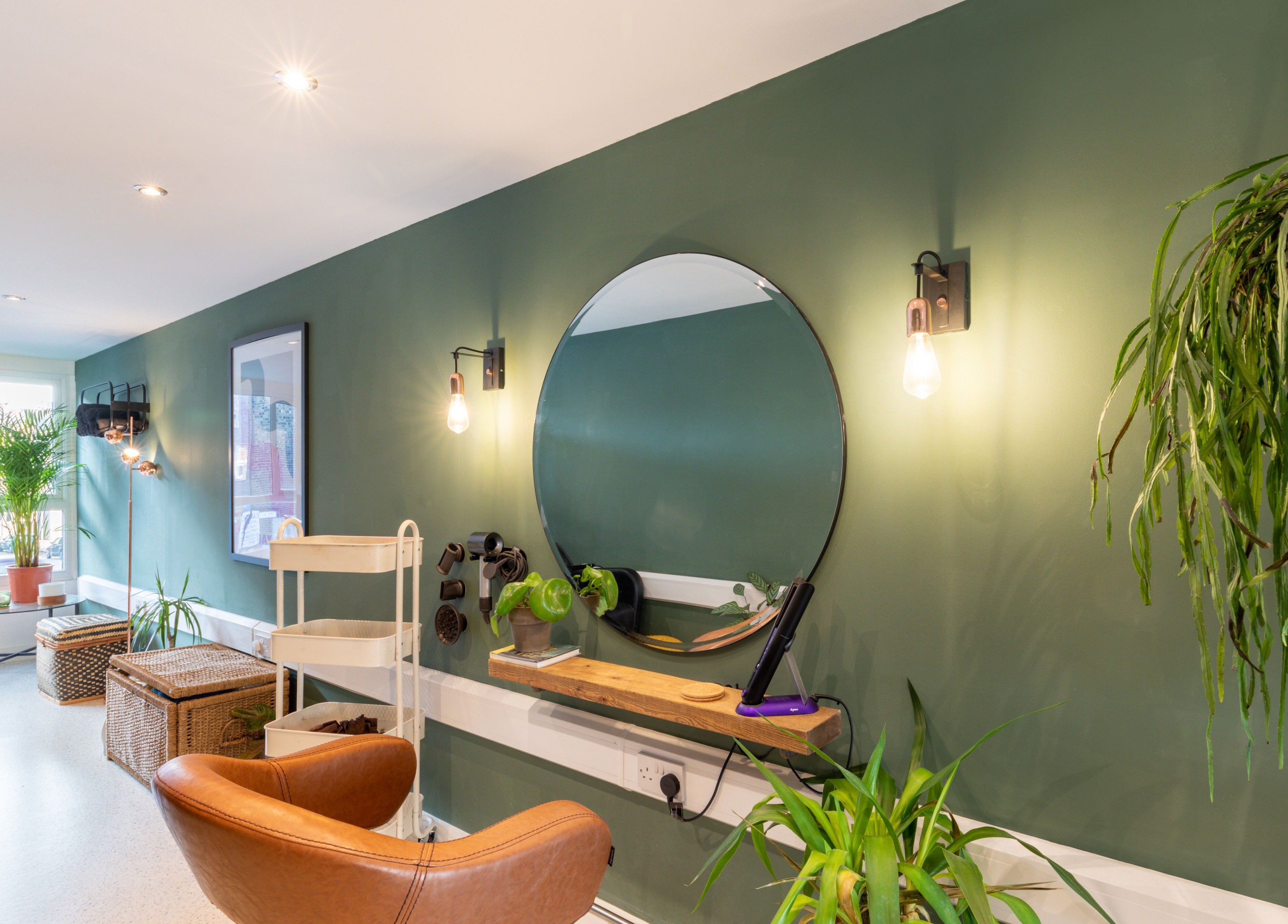 Bright, tranquil interior of Re:Create Hair Studio in London, England, GB, with plants and stylish decor.