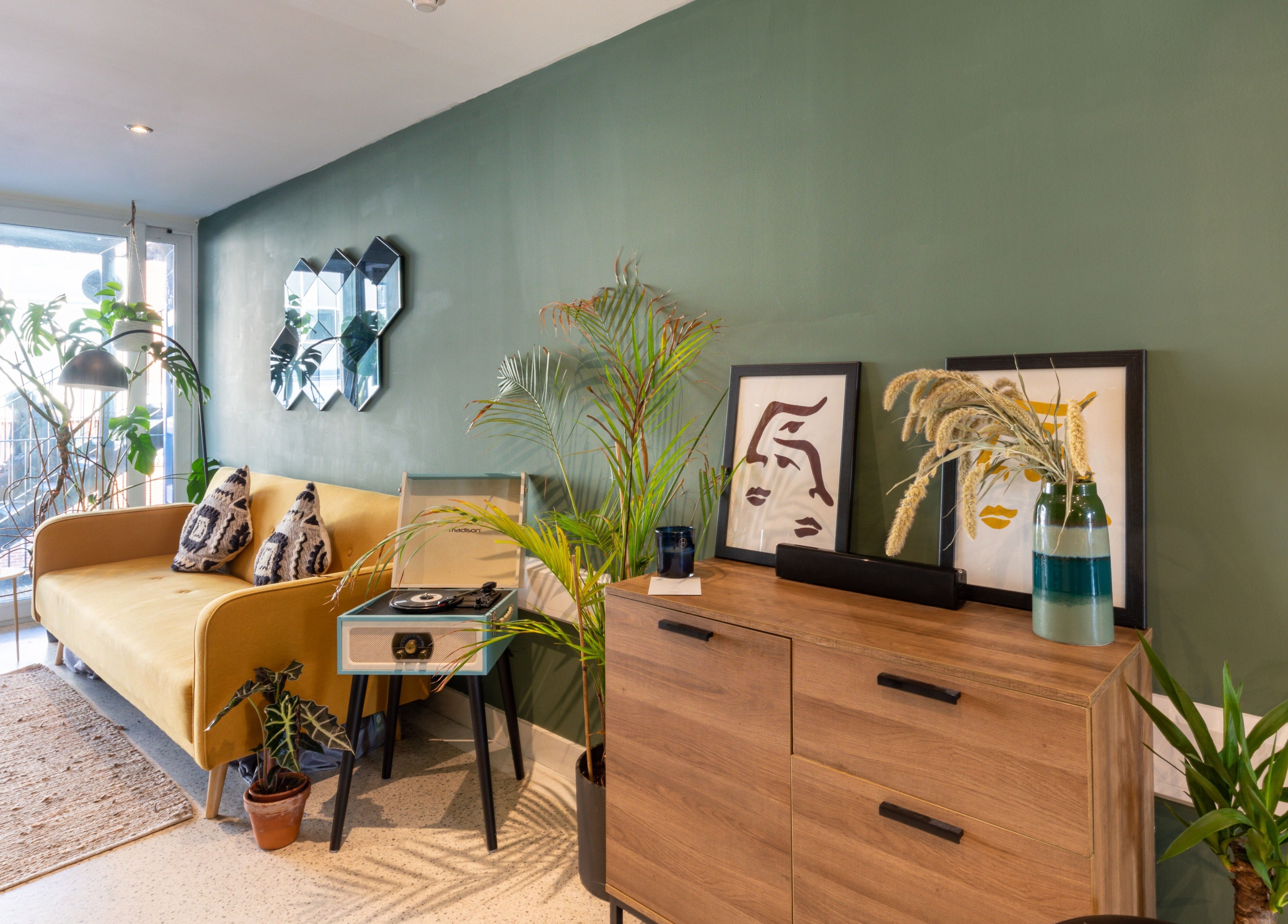 Cozy interior of Re:Create Hair Studio in London, England with lush plants and modern decor.