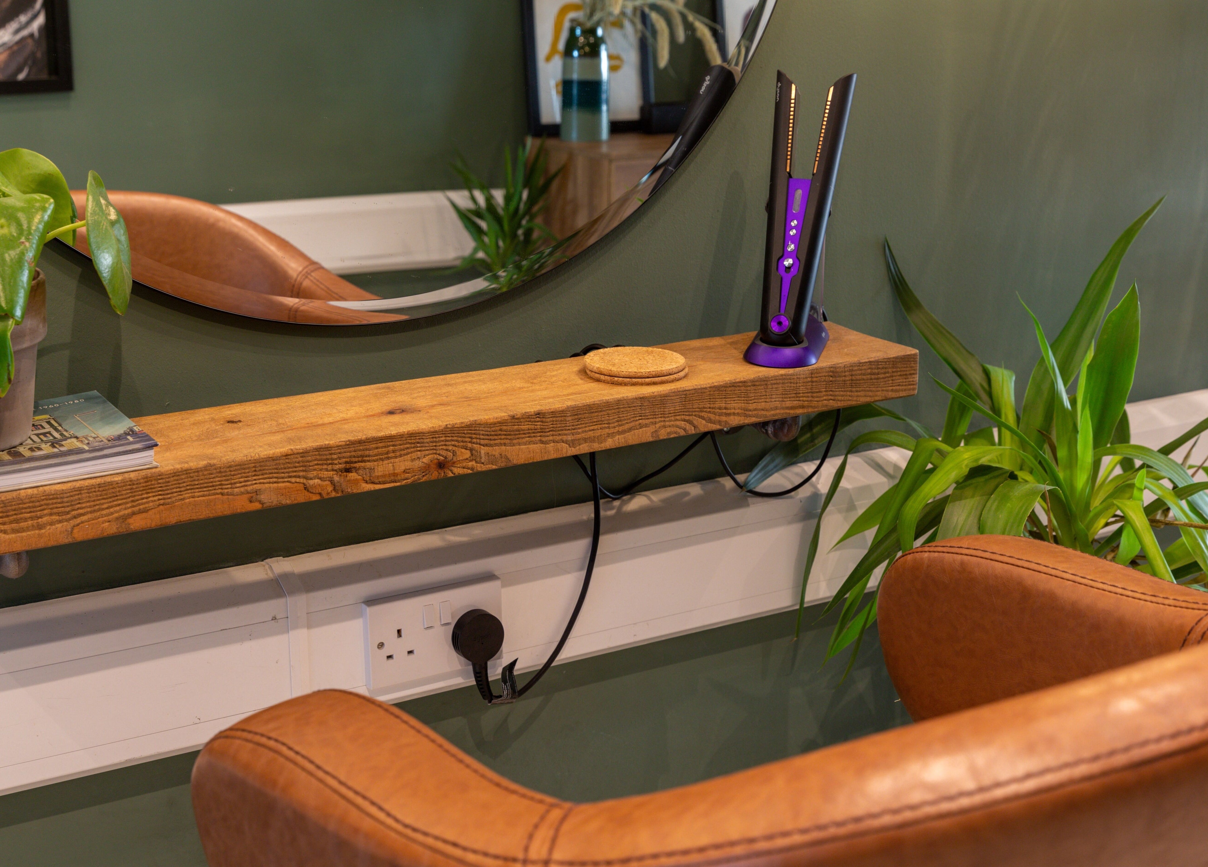 Inviting styling chair and greenery at Re:Create Hair Studio, London, England, GB.