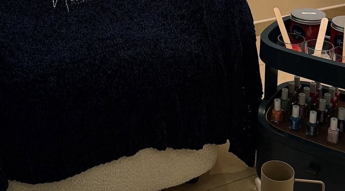 Cozy treatment area at Numi Beauty Studio in Abu Dhabi, Abu Dhabi, AE with nail polishes and spa essentials.