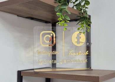 Greta Glamour Look's elegant social media sign on wood shelf, Leicester, England, GB.