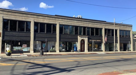 Elegant building exterior of booking hair in Lahore, Punjab, PK under a clear blue sky.