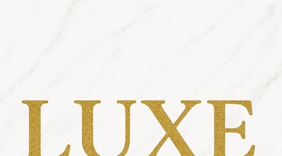 Elegant Luxe Lashes logo with gold lettering on a white marble background in Birstall, England, GB.