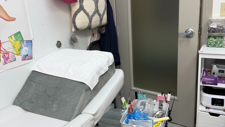 Comfortable nail treatment room at QT Nail Studio, Buford, Georgia, US, featuring a plush bed and organized supplies.