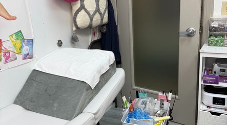 Comfortable nail treatment room at QT Nail Studio, Buford, Georgia, US, featuring a plush bed and organized supplies.
