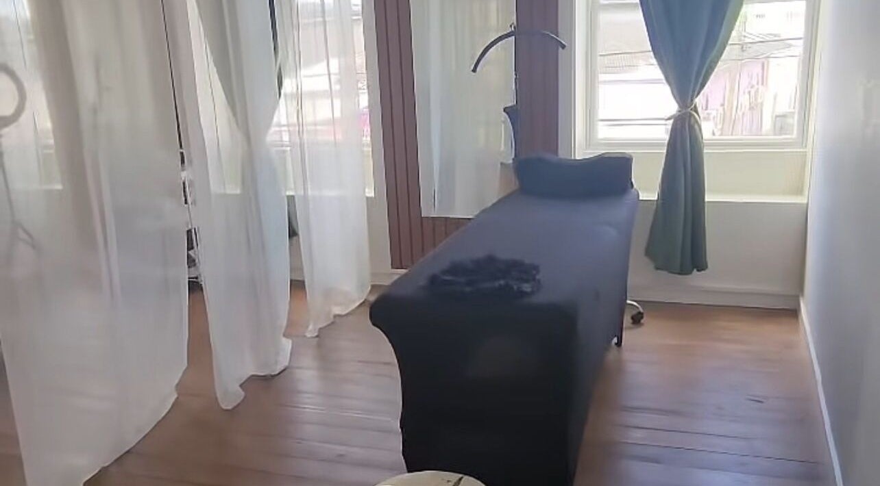 Elegant treatment room at Shen Lash Bar, Bridgetown, Saint Michael, BB, with soft lighting and cozy bed.