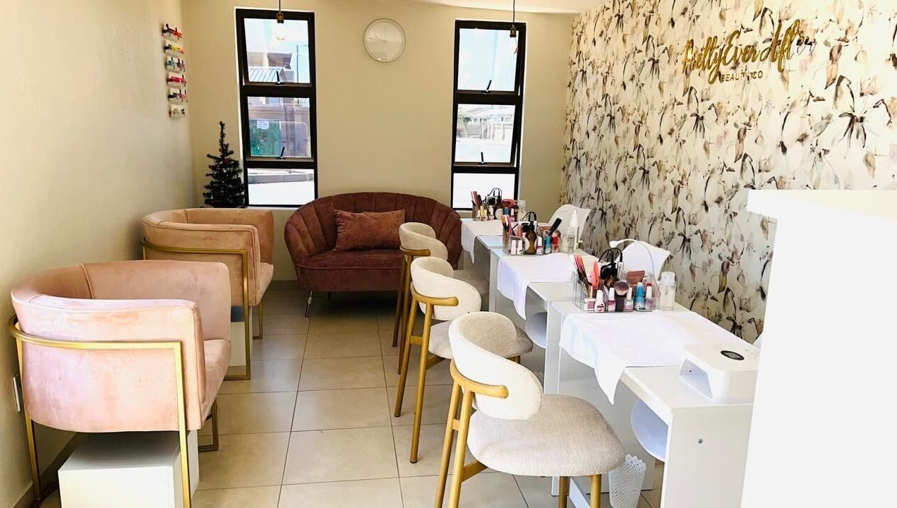 Chic beauty lounge at Pretty Ever After, a wellness venue in Benoni, Gauteng, ZA, featuring elegant seating and decor.