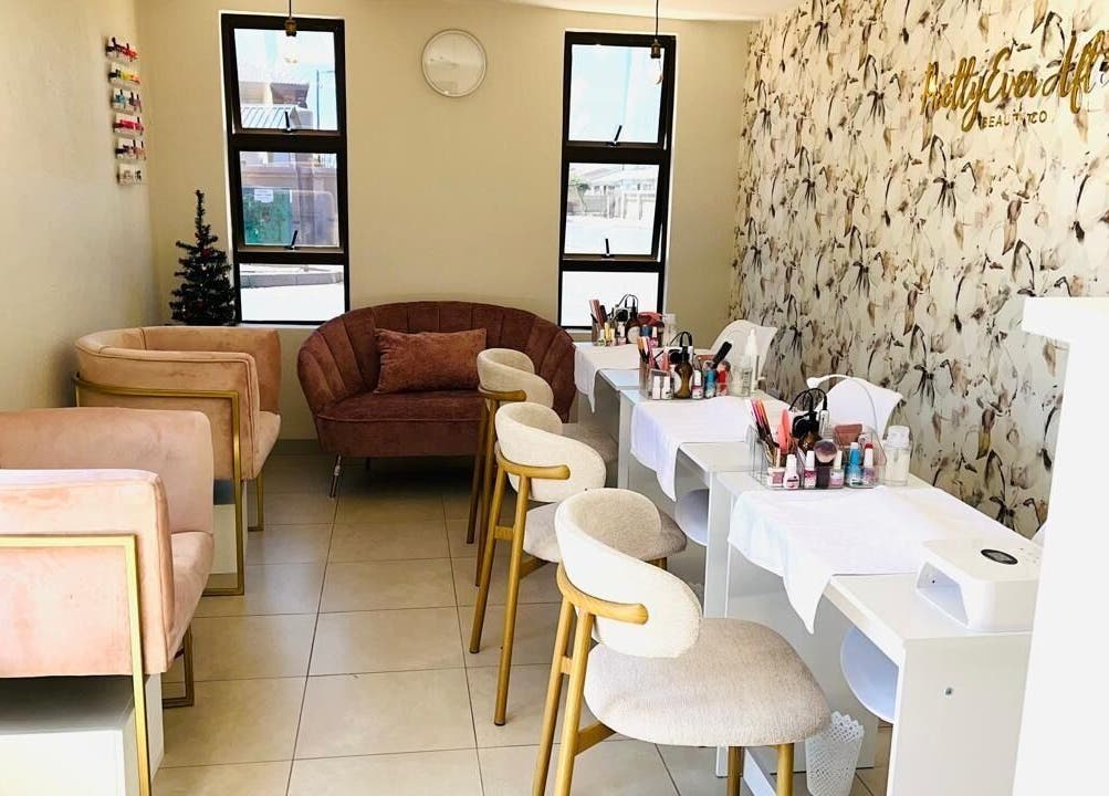 Chic beauty lounge at Pretty Ever After, a wellness venue in Benoni, Gauteng, ZA, featuring elegant seating and decor.