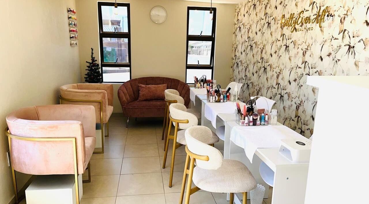 Chic beauty lounge at Pretty Ever After, a wellness venue in Benoni, Gauteng, ZA, featuring elegant seating and decor.